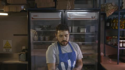 Chef doing acrobatics with the dough of a pizza