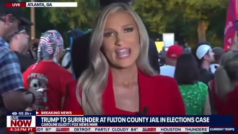 People chant "We love Trump!" outside the Fulton County jail