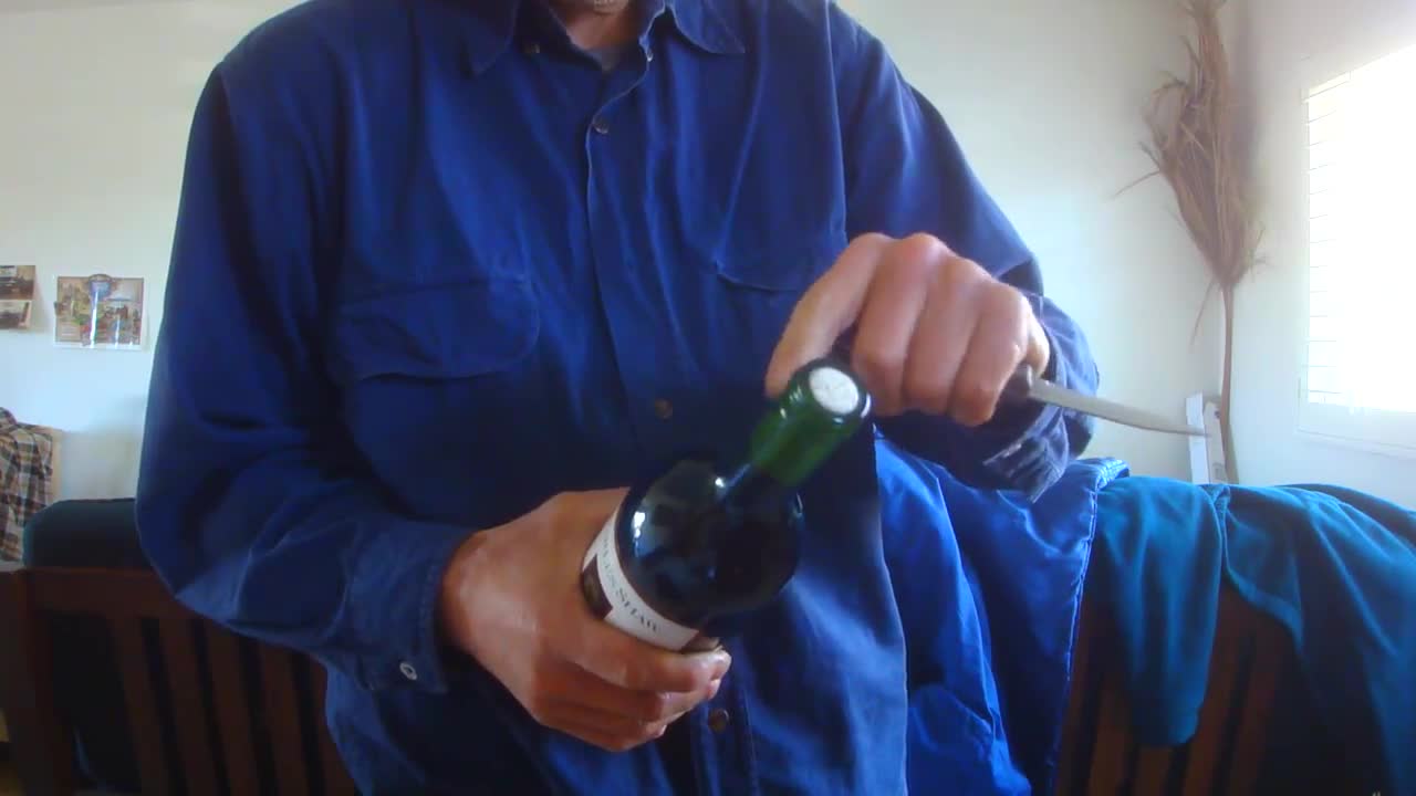 Open a wine bottle with a small knife