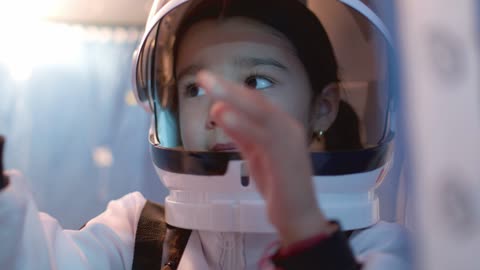 A young girl having fun with a toy spaceship.