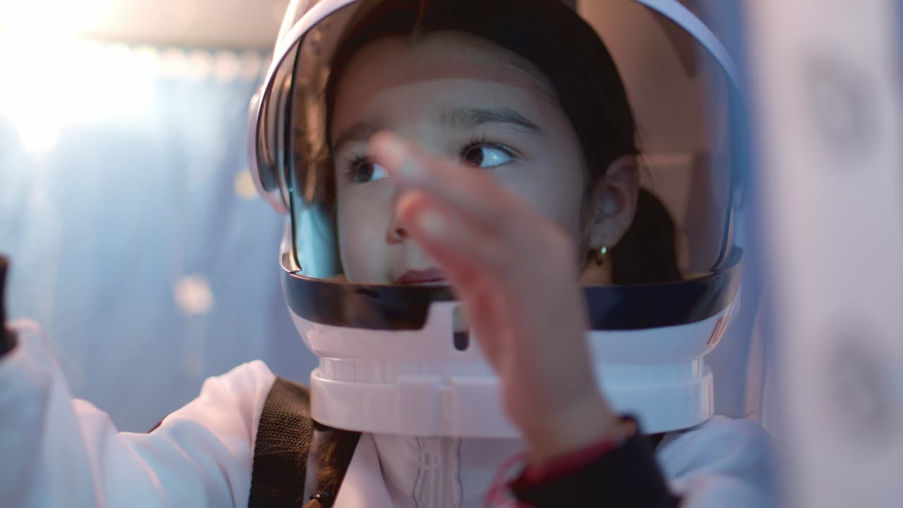 A young girl having fun with a toy spaceship.