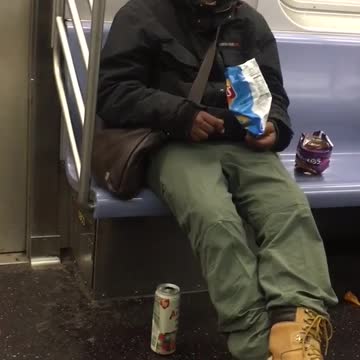Guy is sleeping and also eats bags of doritos and lays chips on subway train