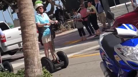 Weekend u old people ride segways down sidewalk