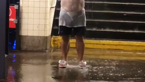 Man with hat and white shirt under water falling