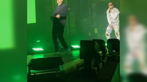 Gunna let's a fan who jumped on stage with him perform with him