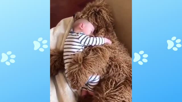 Baby sleeping hugging the dog