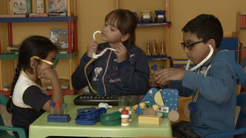 Children play with each other as doctor and patient and read children's books while happy