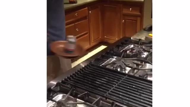 Music guy in kitchen flips beer in skillet and then drinks it