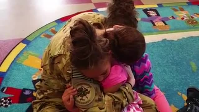 Deployed mom surprises twin daughters at school