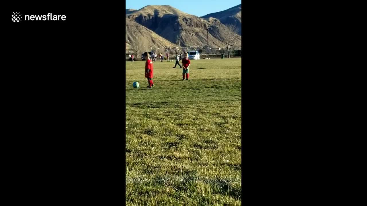 Frustrated little boy yells at soccer ball after missing his kick