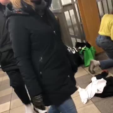 Man wiping subway floor has dirty black socks