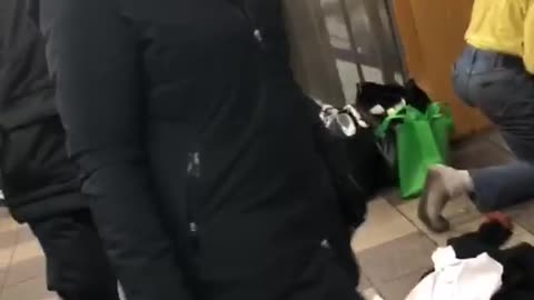 Man wiping subway floor has dirty black socks