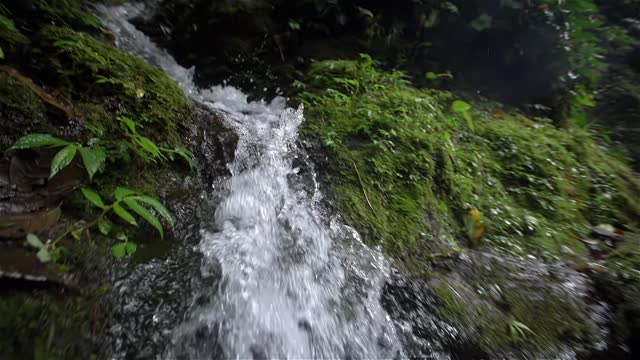 Tracking shot of small waterfall