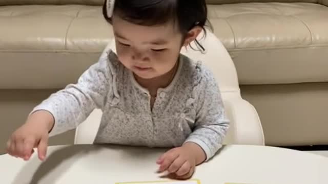 Baby having fun studying animals.