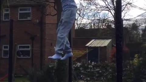 Kid blue shirt stripes trampoline backflip fail foot caught on net