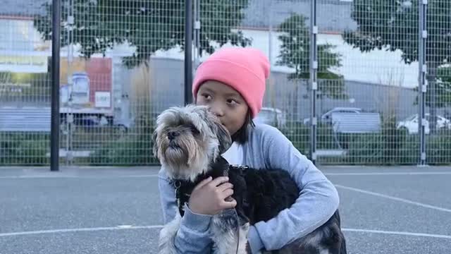 Kid Holding a Dog