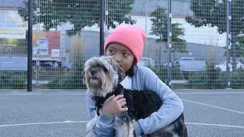 Kid Holding a Dog