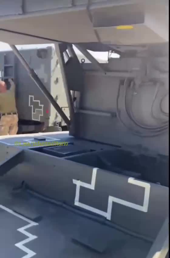 Ukraine War - Ukrainian servicemen apply camouflage to vehicles