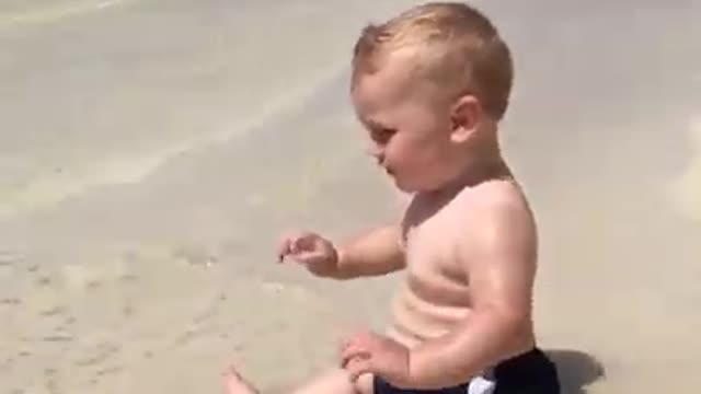 Cute beach baby scared of waves. Short video