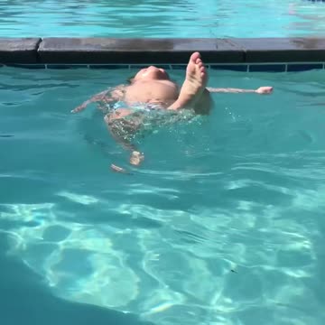 1-year-old does 'Superman' pose before jumping into pool