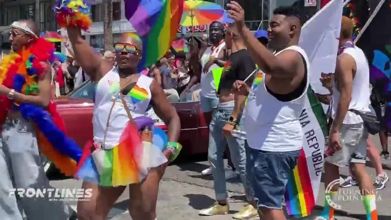 A woman forces a child to watch the LA Pride parade