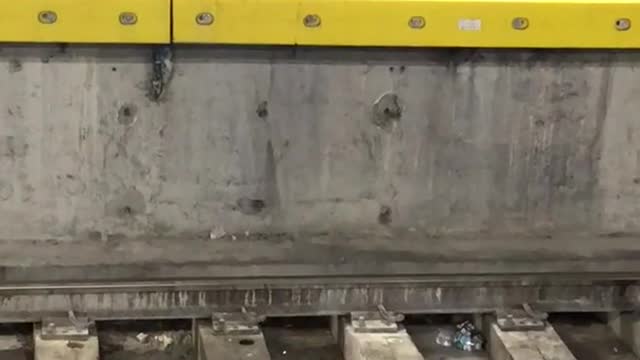 Man plays air drums across subway platform