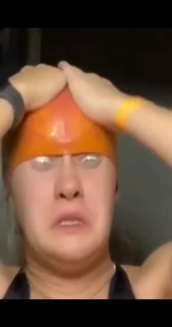 We elegantly put on a swimming cap