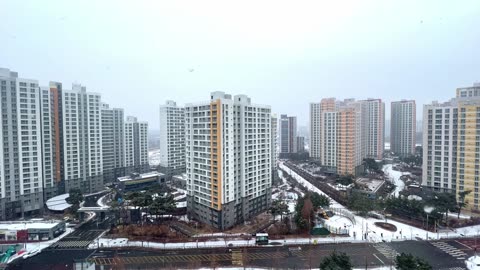 a high-rise apartment complex with snow in winter