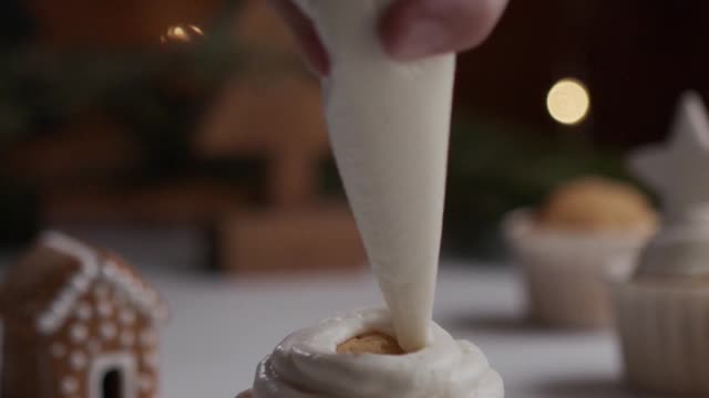 decorating a cupcake with gingerbread cookie