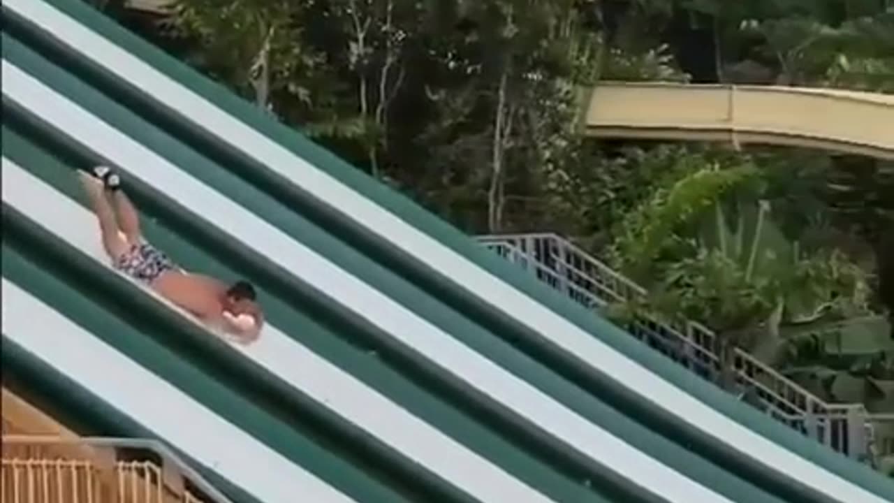 Man descends waterslide headfirst, executes impressive flip & dive