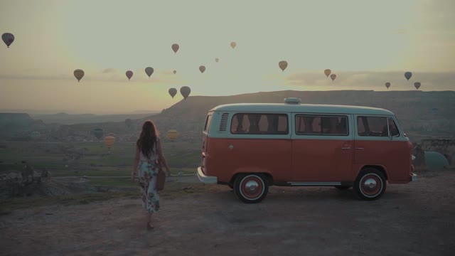 How A Beautiful View Of A Walking Girl And Hot-Air Balloon At Sunset