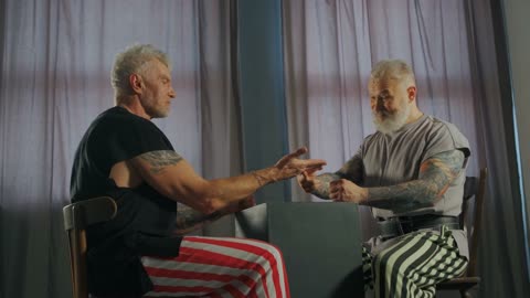 Elderly Men Playing Rock Paper Scissors