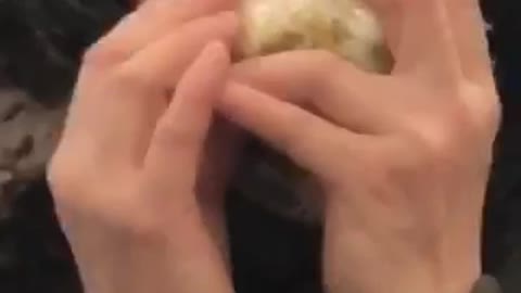 Woman eating an entire onion