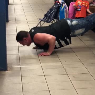 A man doing push ups with feet on a bench