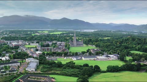 Aerial Footage Of A Town Surrounded By Scenic Natural Landscape