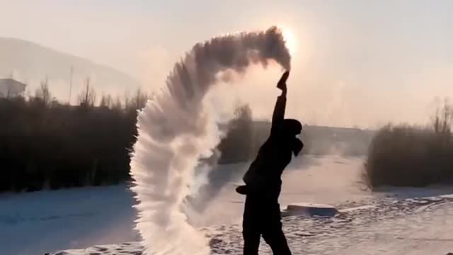 The guy throwing the snow in the sky