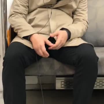 Man sleeping subway earphones phone on floor