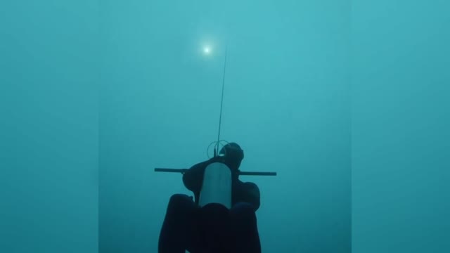 Free Diver Travels Into Darkness Of Frozen Alpine Lake