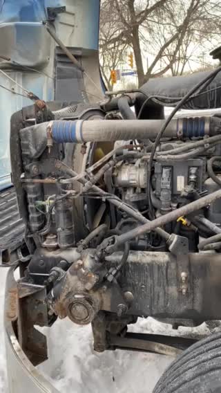 Mac Truck running engine drivers side view