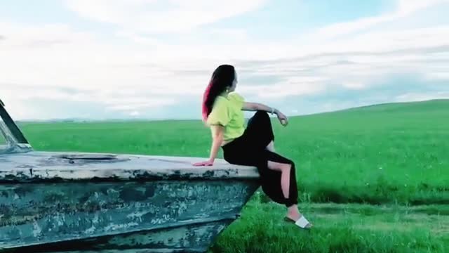 A beautiful girl posing on grassland