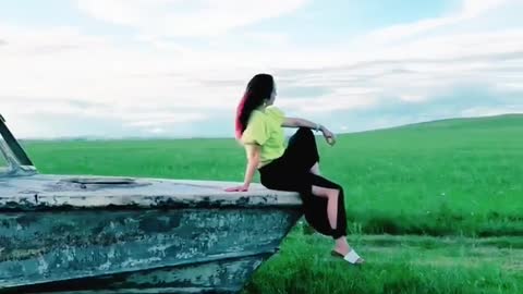 A beautiful girl posing on grassland