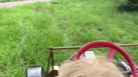 Boy Takes Dad for a Tour in Miniature Model T