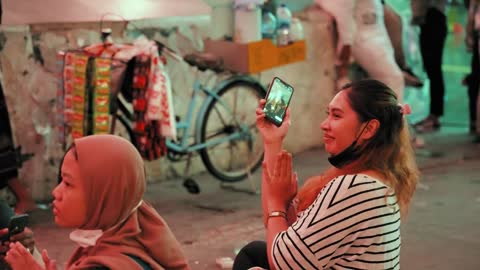 Tracking Shot of Women Clapping in Jakarta