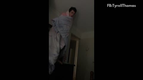 Music guy wrapped in blue blanket jumps off bunk bed