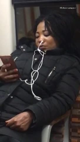 Woman in black jacket white ear phones in nose
