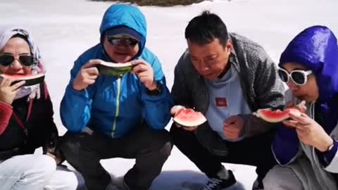 It's so cool for our family to eat watermelon on the snowy mountain