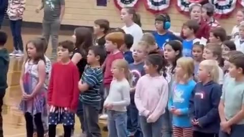 An entire school gym full of kids singing ‘God Bless the USA’