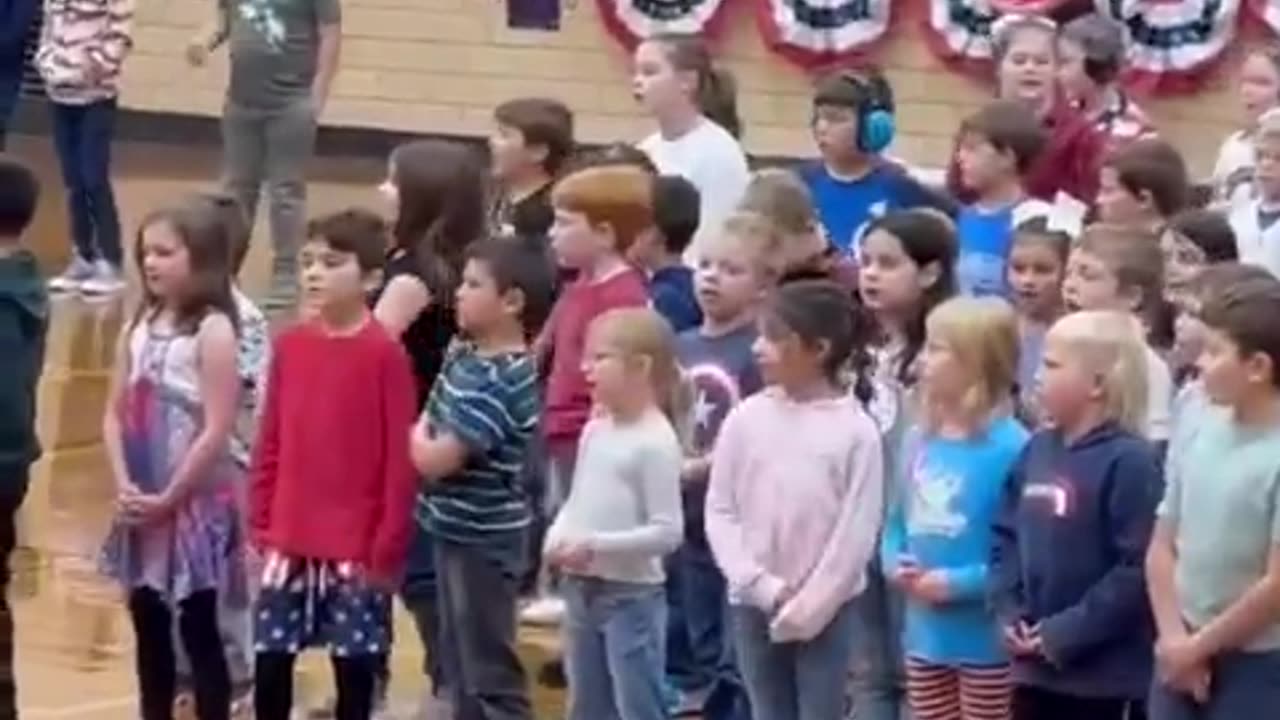 An entire school gym full of kids singing ‘God Bless the USA’