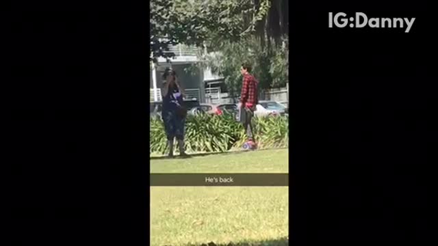 Guy in red plaid flannel rollerskating around with boombox