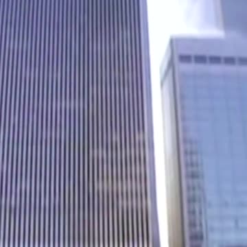 Reporter on camera as tower begins to collapse